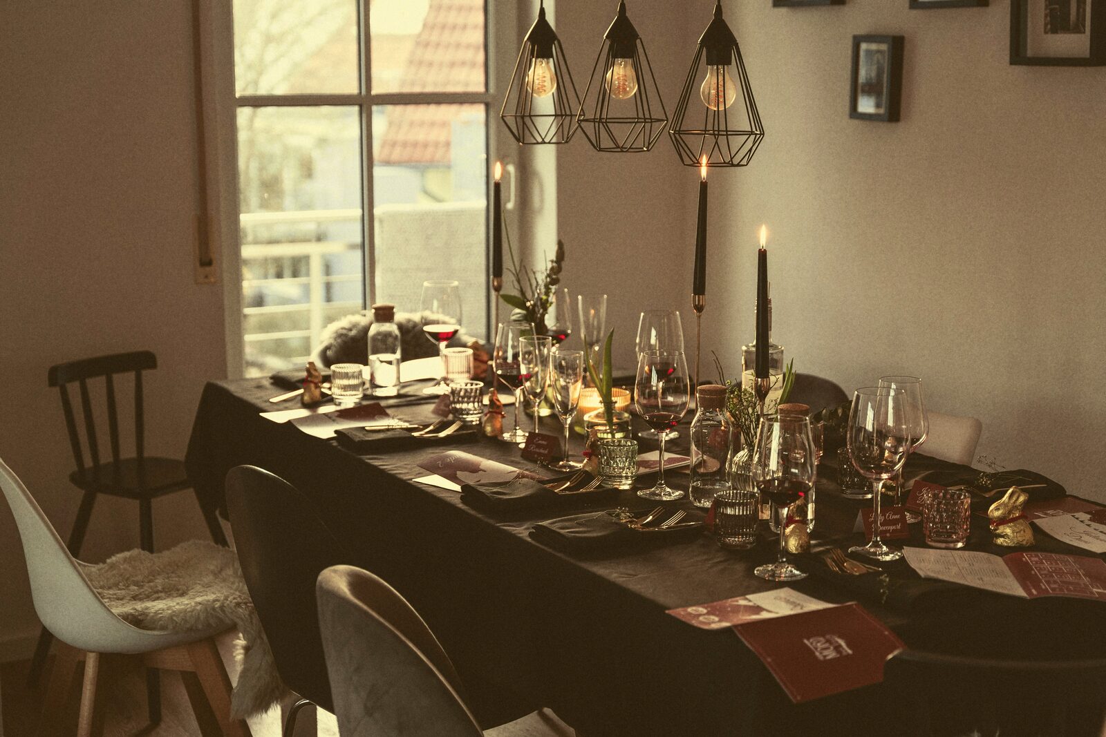 A candlelit dinner table set with wine glasses and place settings.